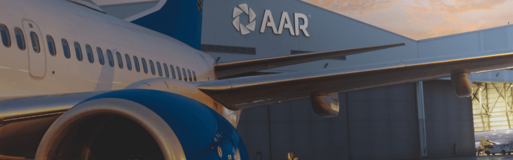 AAR aircraft with B&H Worldwide logistics team at airport.