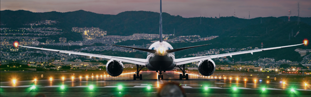 Boeing aircraft on runway with large flight control surface in focus.