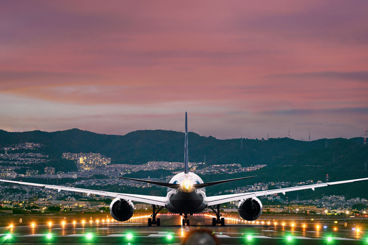 Aircraft cargo loading for Boeing aircraft at sunset.