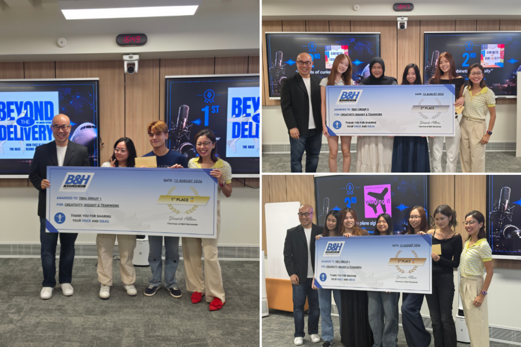 Group of students and professionals with large checks at aerospace event.